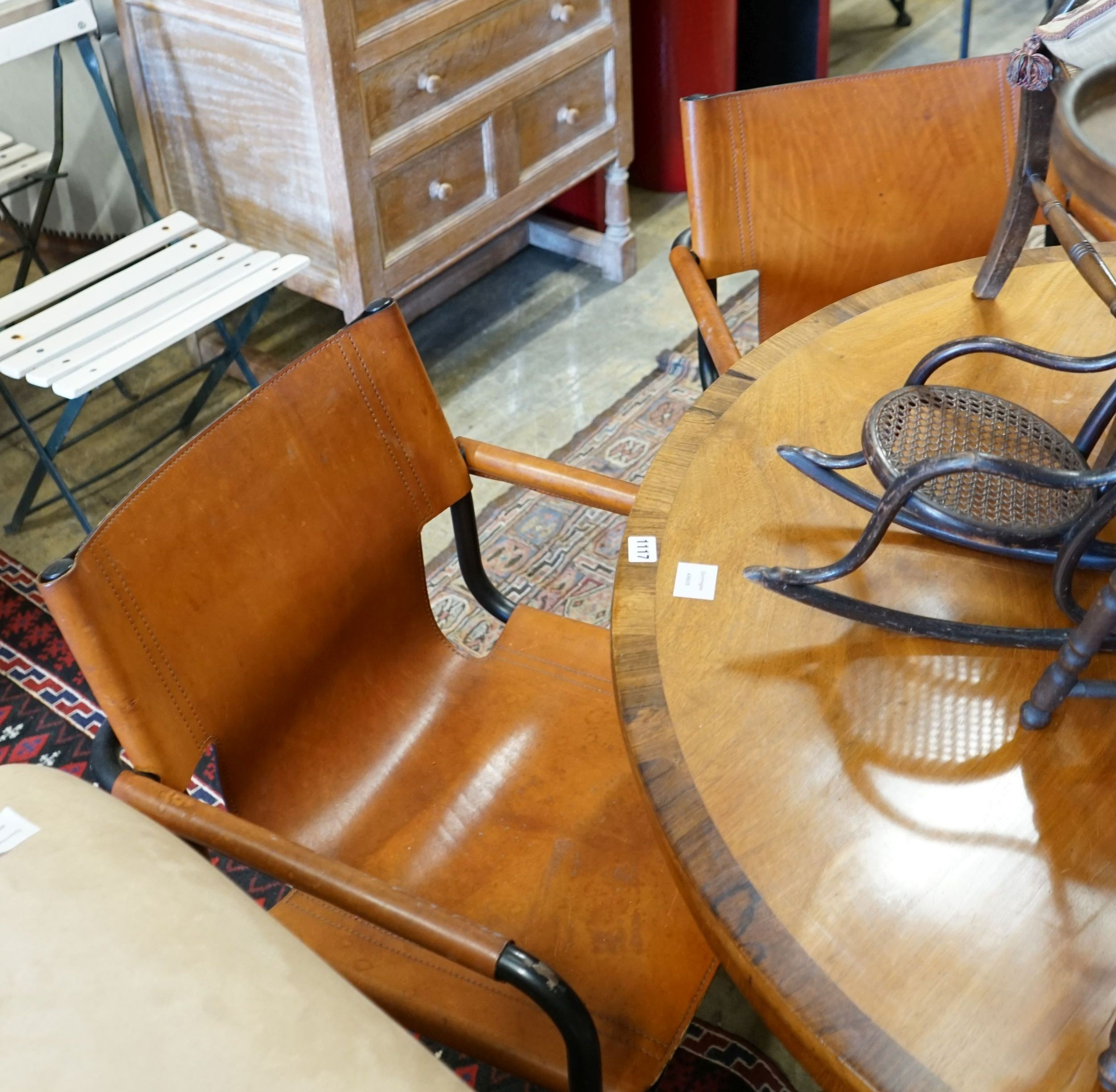 A set of four contemporary tan leather cantilver dining chairs, width 56cm depth 50cm height 79cm